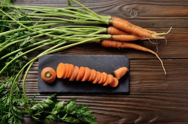 top view at fresh organic carrots on kitchen woode 2023 11 27 05 28 26 utc